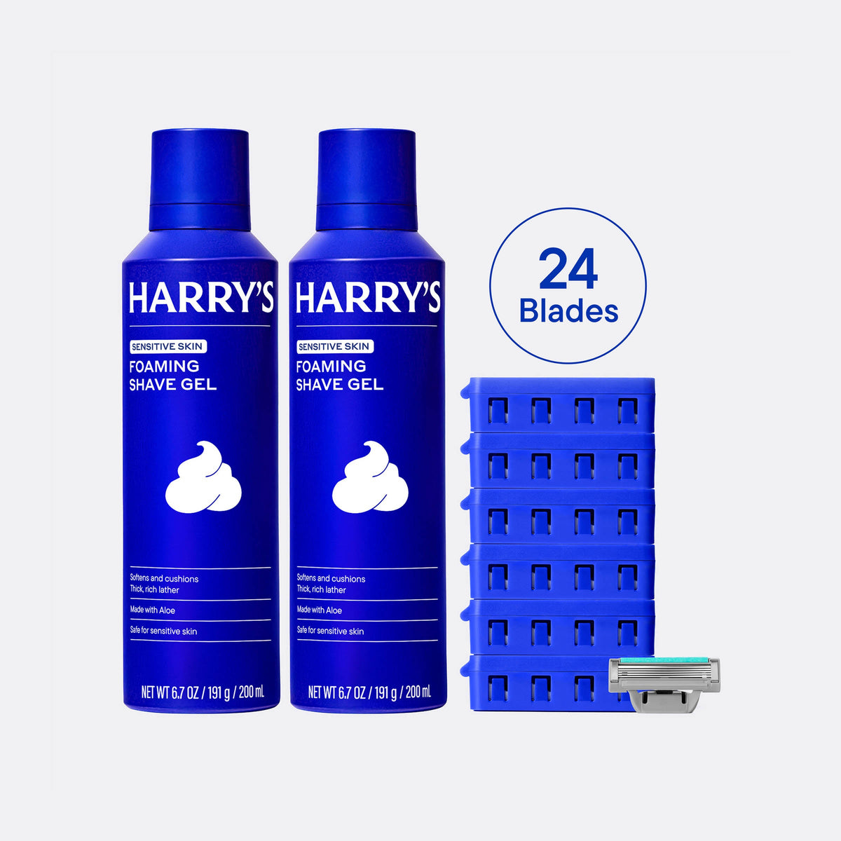 Two bottles of Harry's foaming shave gel with a stack of razor heads and a razor on a white background.