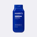 Blue bottle of Harry's shampoo and conditioner on a light gray background