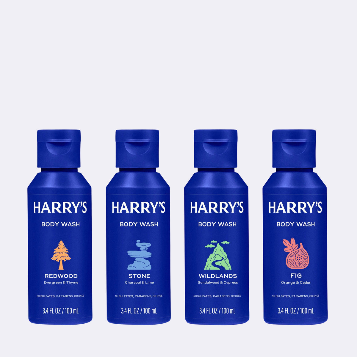 Four bottles of Harry's body wash in blue bottles but different scent lables on a white background