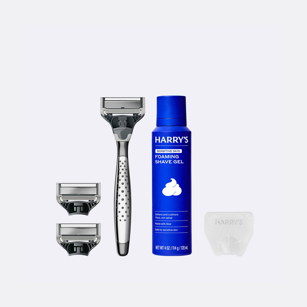 Harry's shaving kit with a razor, shaver head, and foaming shave gel on a white background