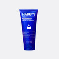Blue tube of Harry's exfoliating facial cleanser on a white background