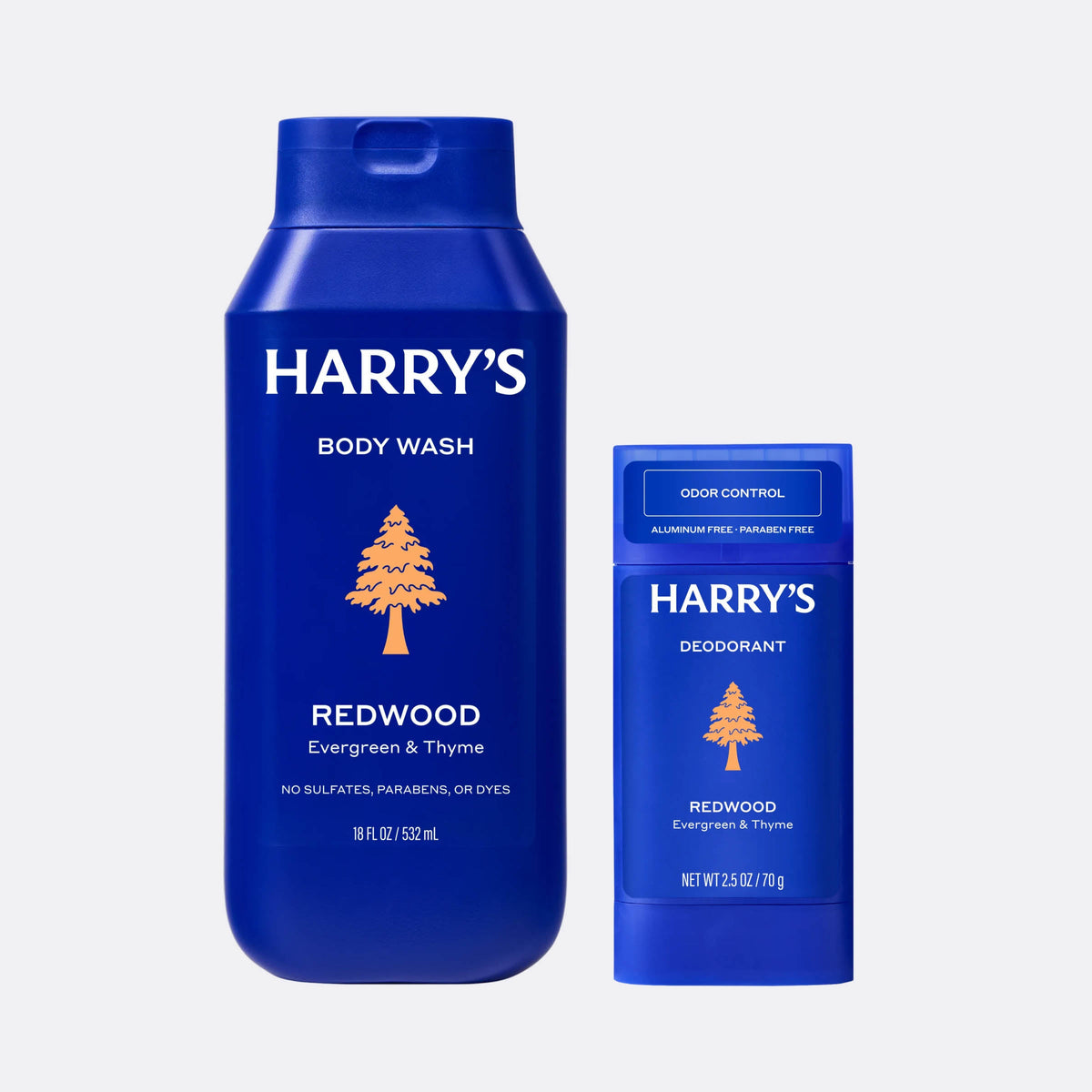 Blue bottles of Harry's body wash and deodorant on a light gray background