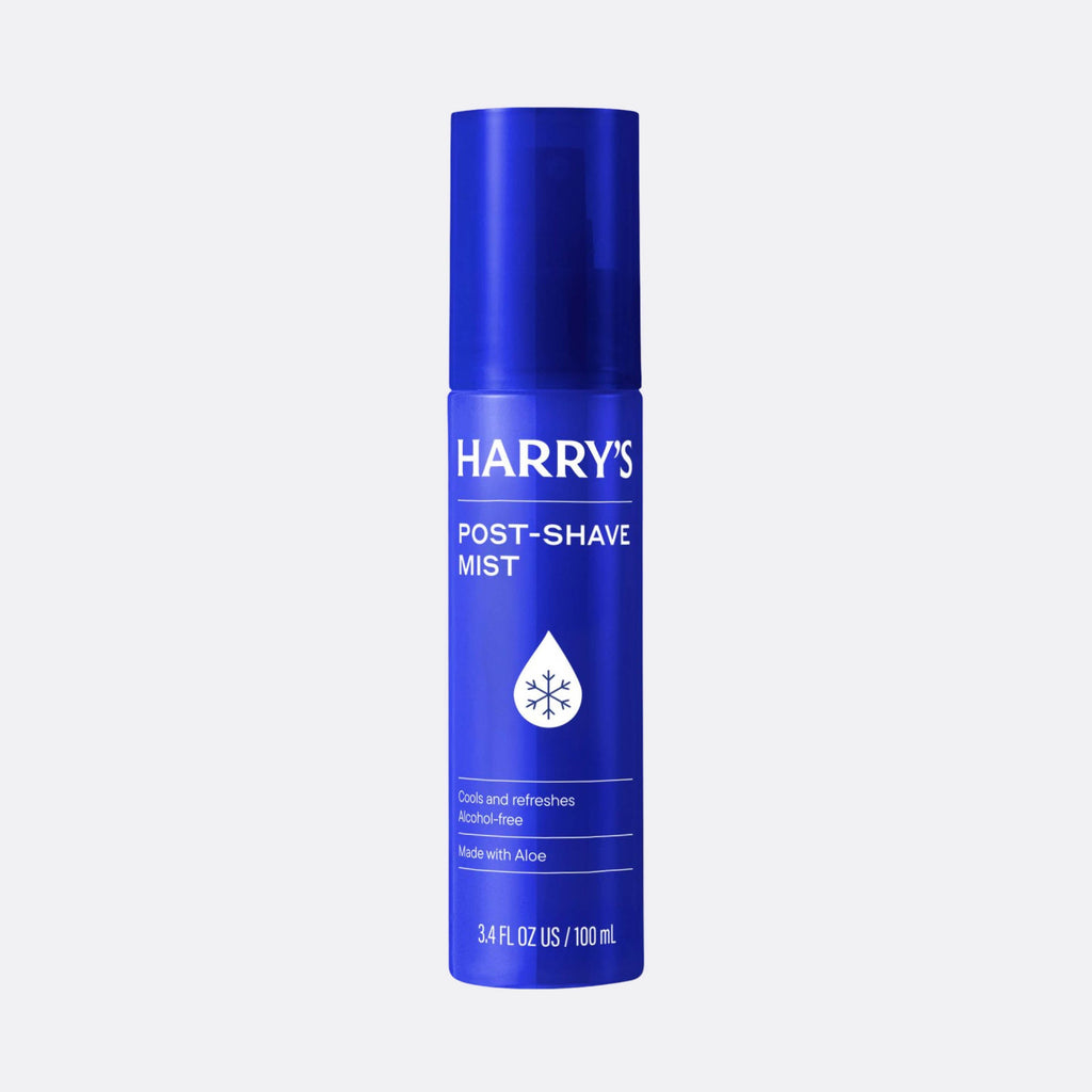 Blue bottle of Harry's post-shave mist on a light gray background