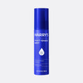 Blue bottle of Harry's post-shave mist on a light gray background