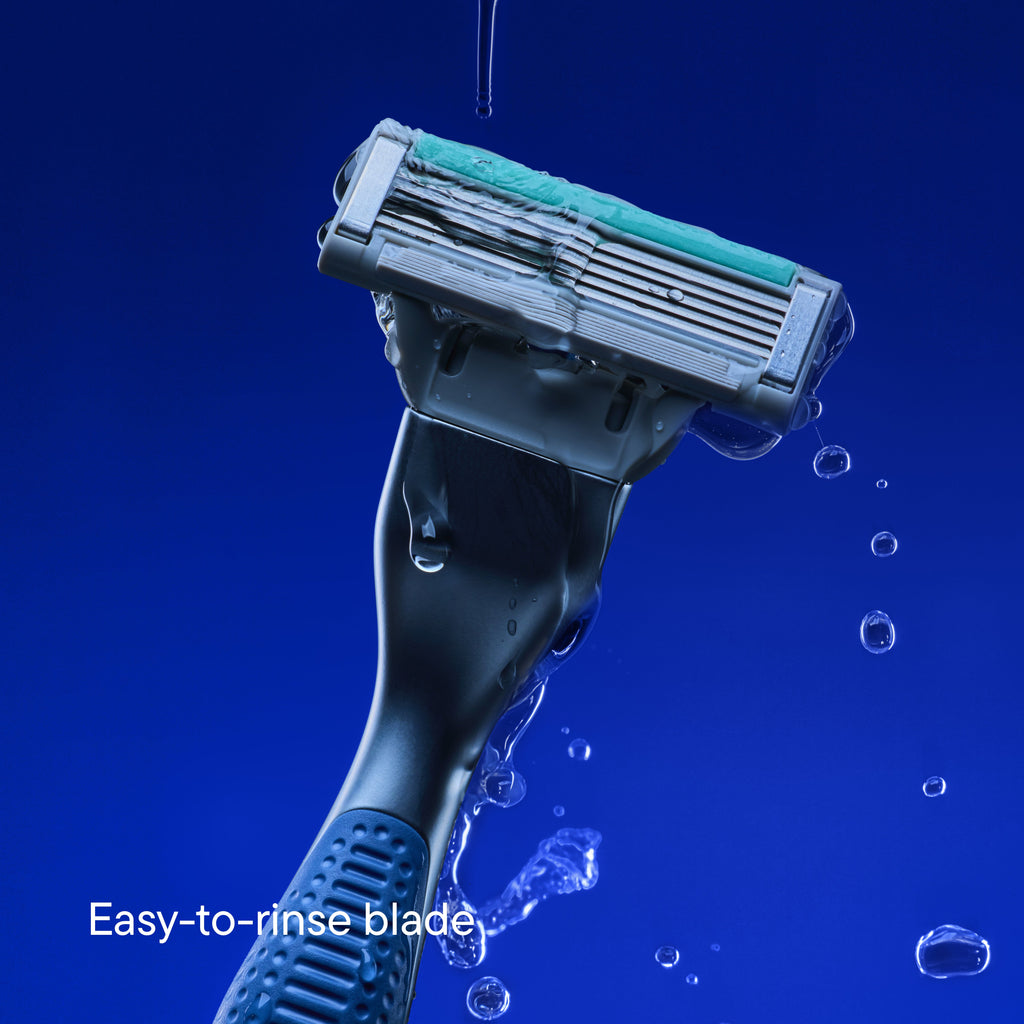 A close-up of a razor blade with water dripping over it against a deep blue background, with the text 'Easy-to-rinse blade' in the lower left corner.