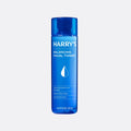 Blue bottle of Harry's Balancing Facial Toner on a light gray background