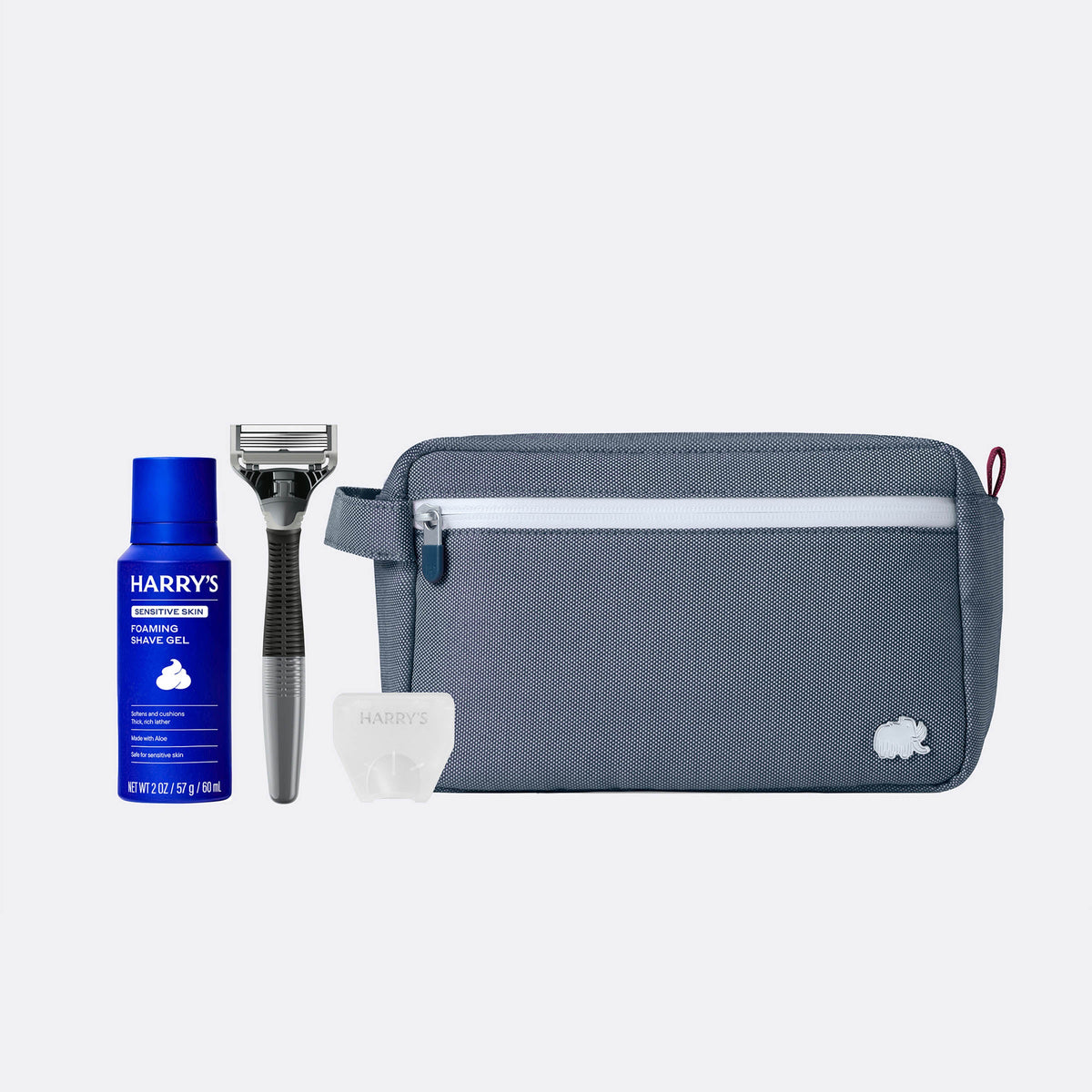 Grooming kit with Harry's shaving gel, razor, and pouch on a white background