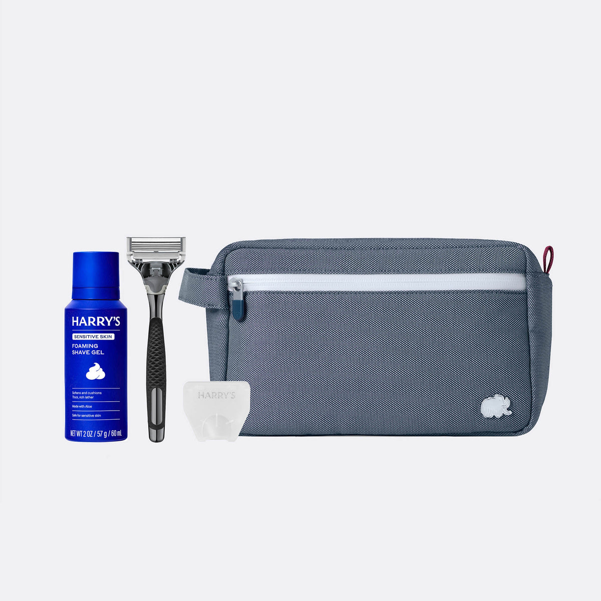 Grooming kit with Harry's shaving gel, razor, and pouch on a white background