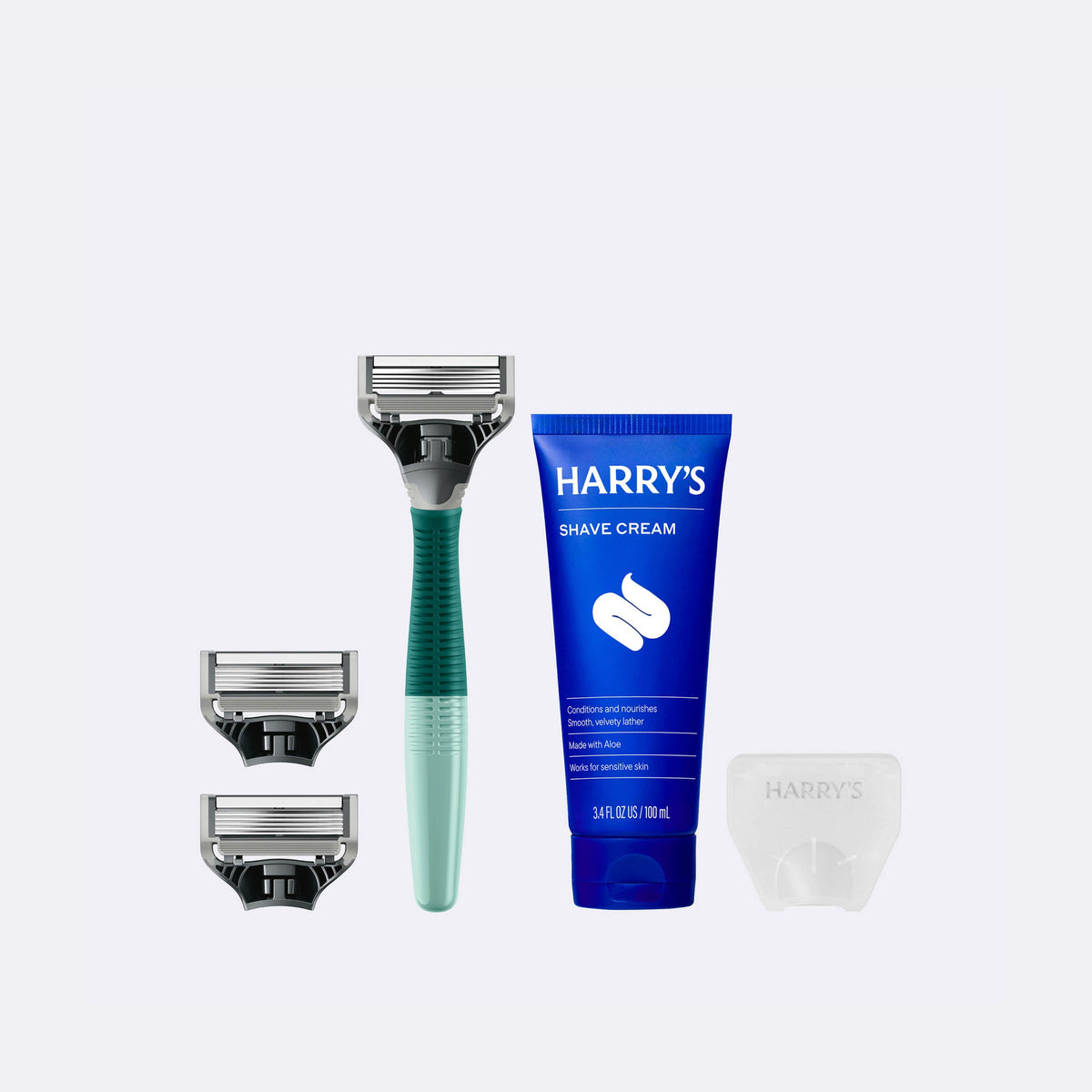 Harry's shaving kit with razor, cream, and razor heads on a white background