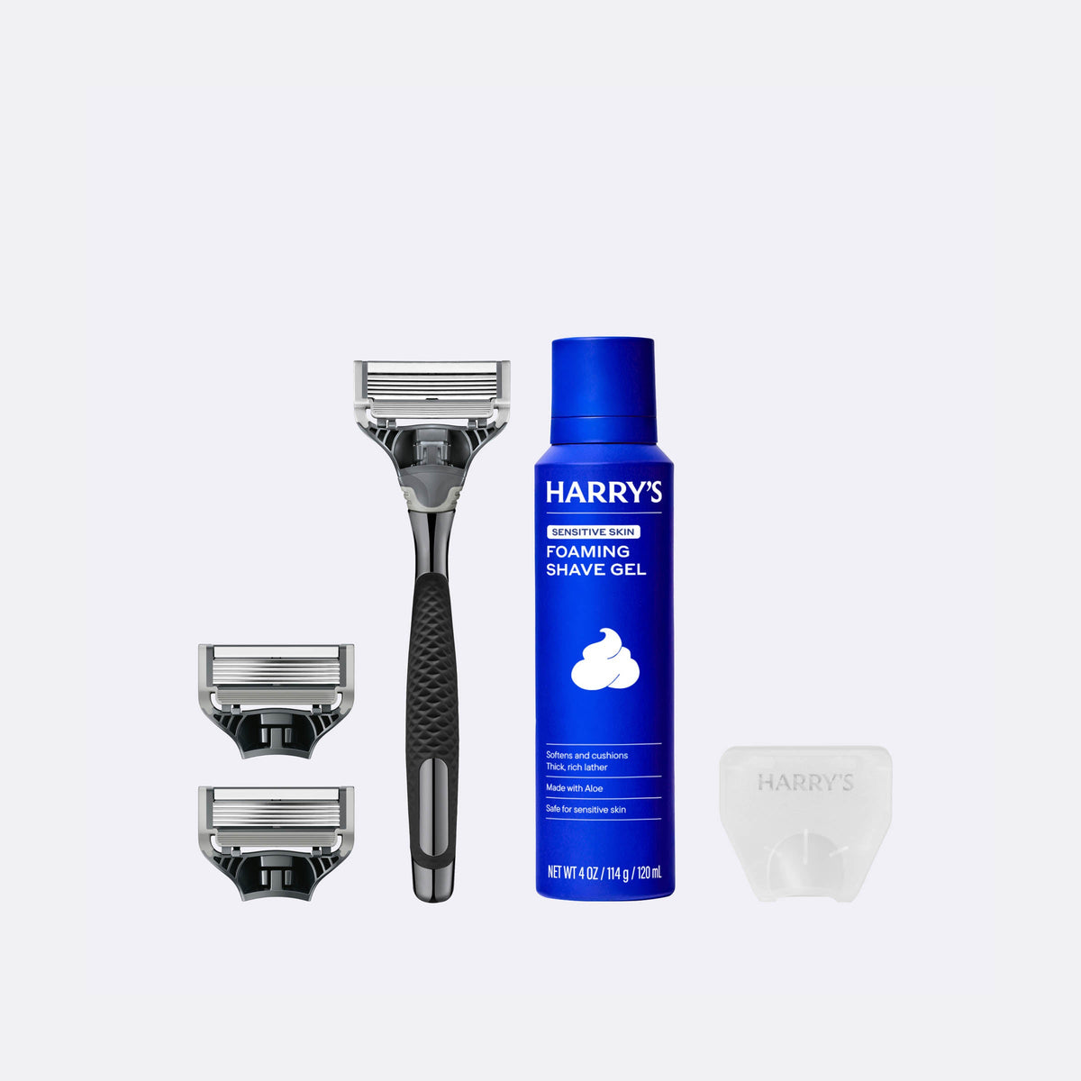 Harry's shaving product set including a razor, shaver head, and foaming shave gel on a white background