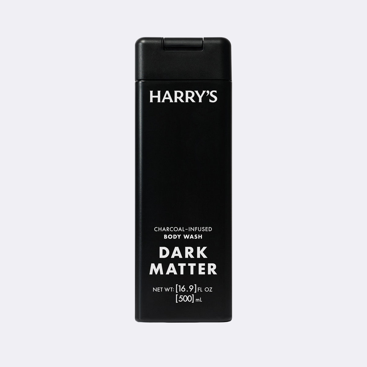 A tall black rectangular bottle of Harry's Dark Matter Charcoal-Infused Body Wash, featuring white text on a light gray background.