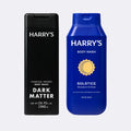 Two Harry's Body Wash bottles on a light gray background: a tall black box labeled Dark Matter and a blue bottle labeled Solstice with a yellow sun graphic.