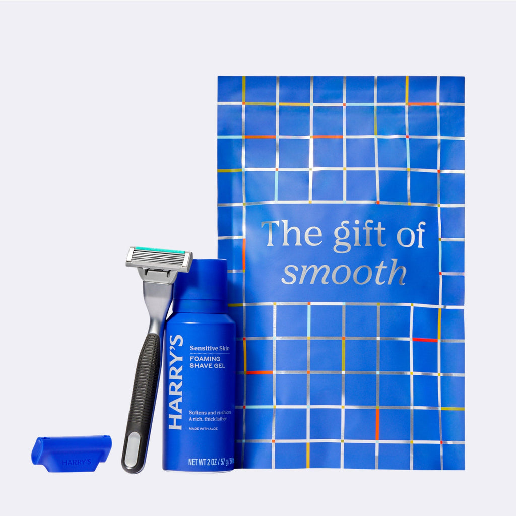 Blue shaving product set with a razor and packaging on a white background