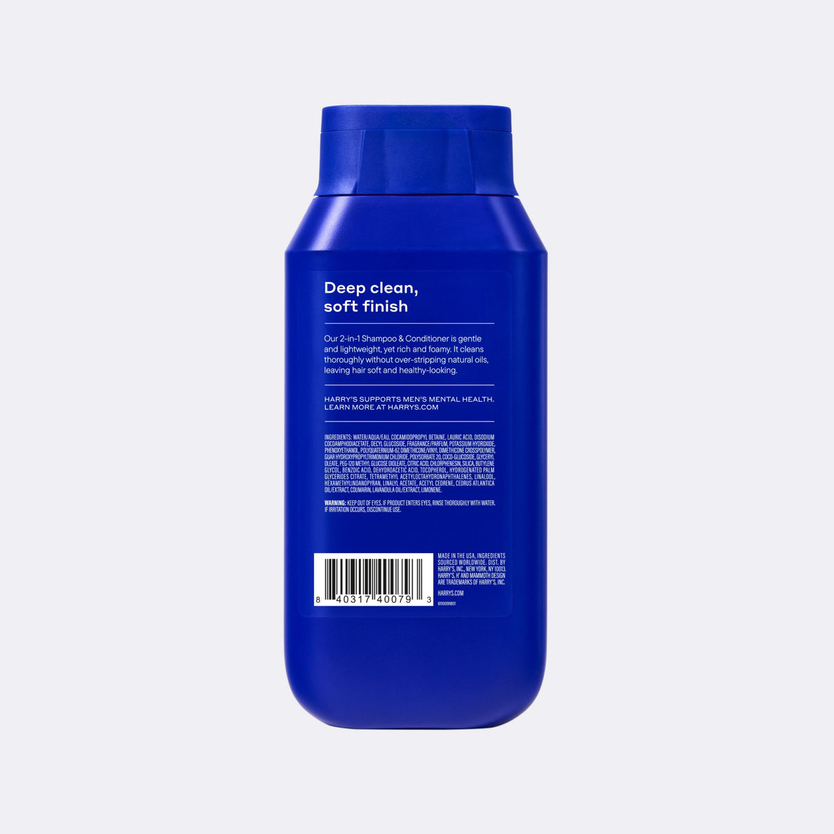 Blue bottle with a label on a light gray background