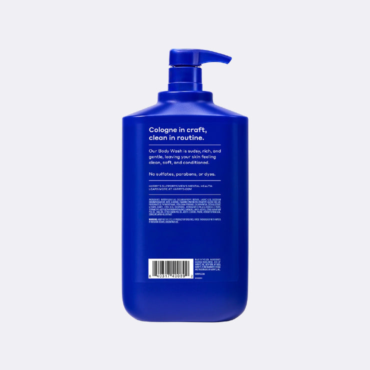 Blue body wash bottle with pump on a light gray background