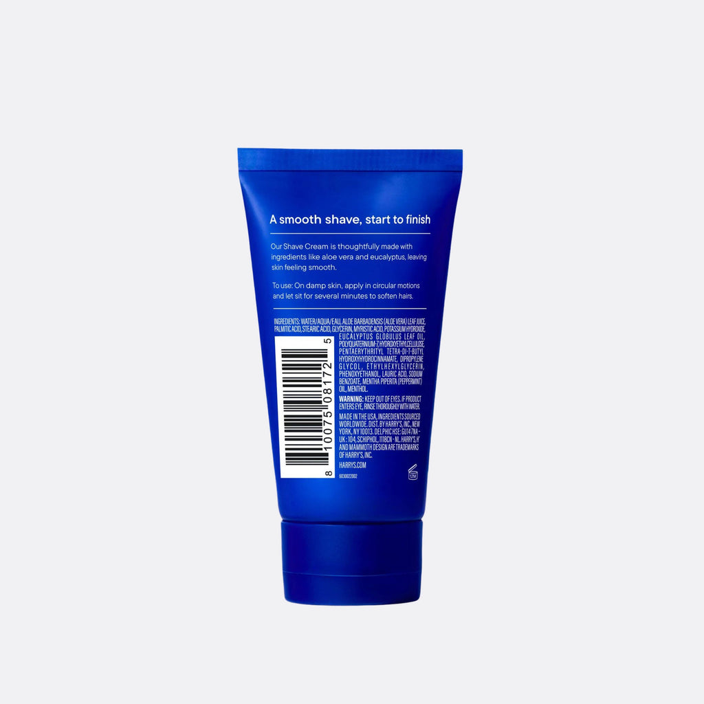 Blue tube of shaving cream with text and a barcode on a white background