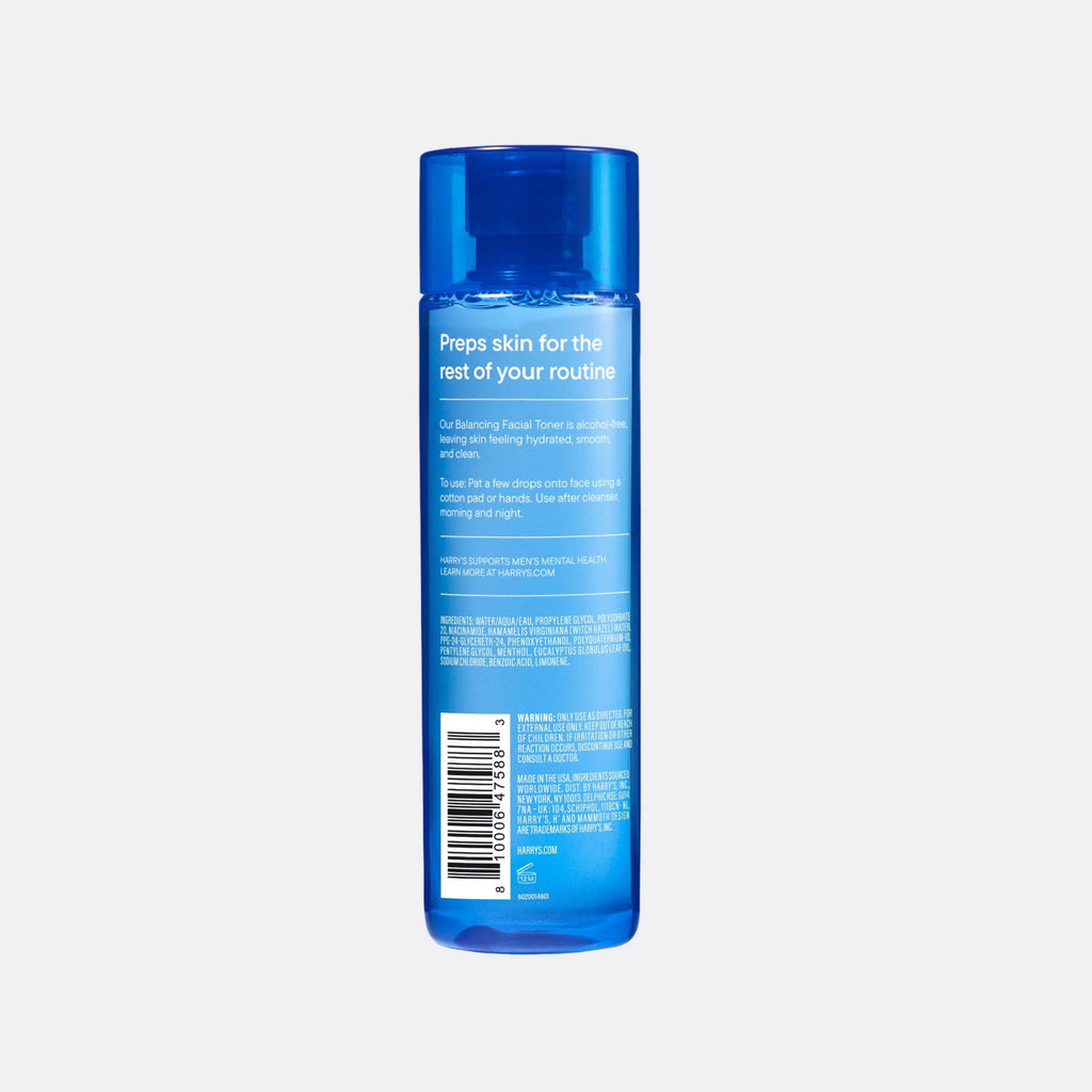Blue skincare bottle with label on a light gray background