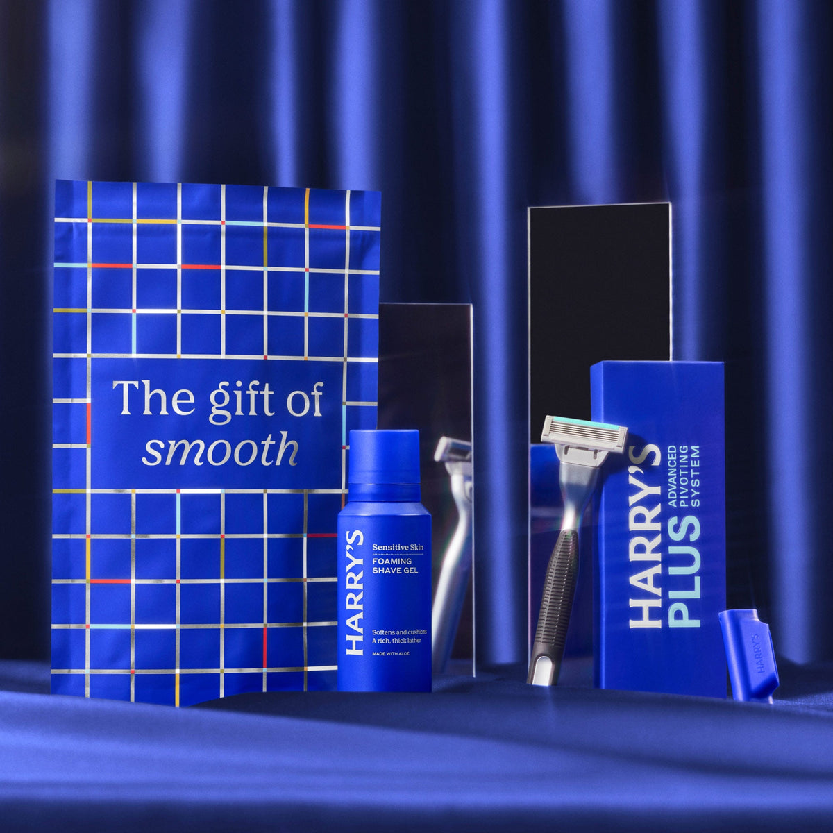 Harry's grooming products including a bottle, razor, and packaging on a blue background.