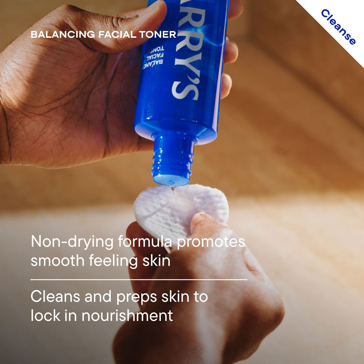 Hand applying a blue bottle of 'HARRY'S' toner to a white cloth on a neutral background.