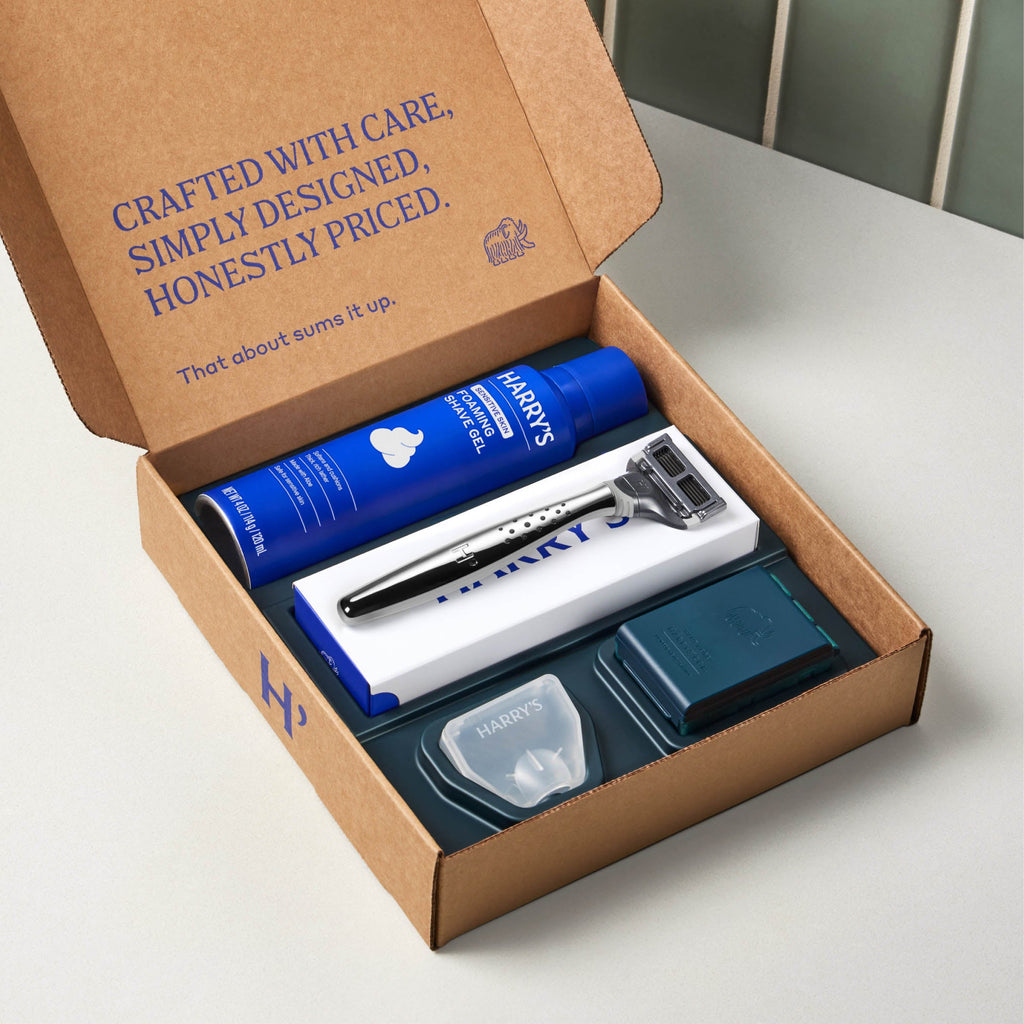Harry's shaving product set including a razor, shaver head, and foaming shave gel on a white background