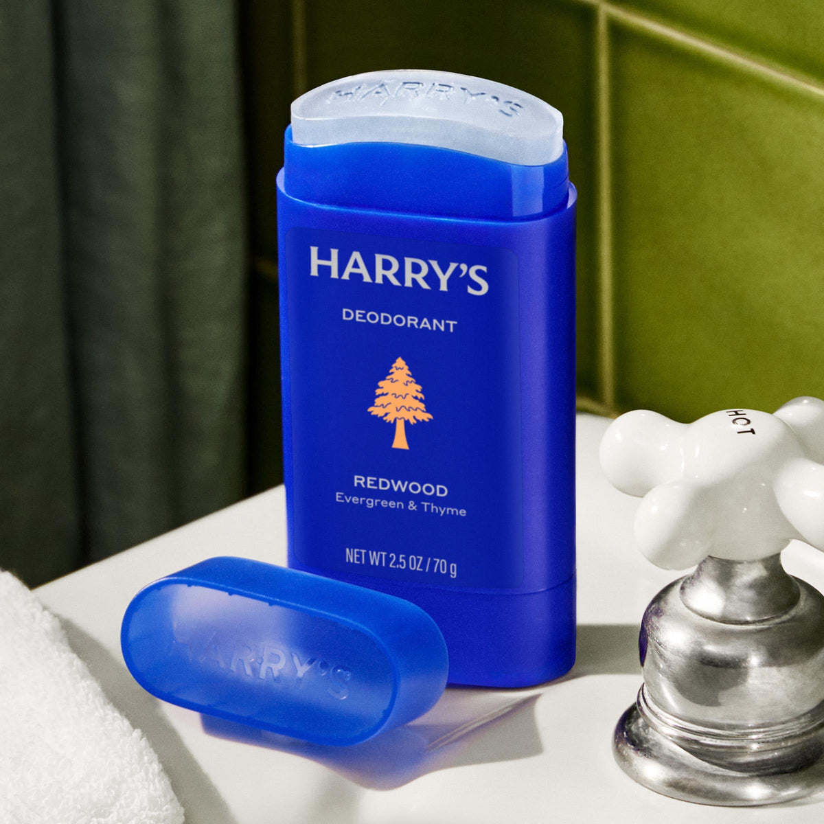 Blue deodorant stick with 'Harry's' branding on a bathroom counter.