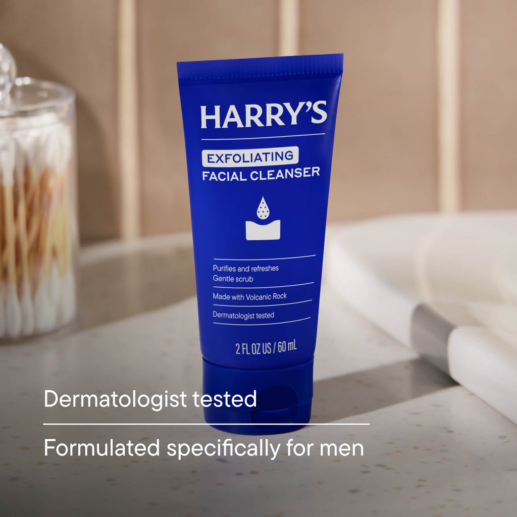 Blue tube of Harry's Exfoliating Facial Cleanser on a bathroom counter.