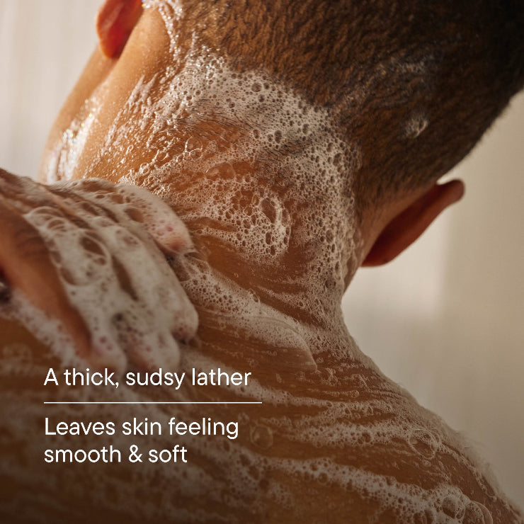Person applying soap to the back of their neck with text " A thick, sudsy lather. Leaves skin feeling smooth & soft."
