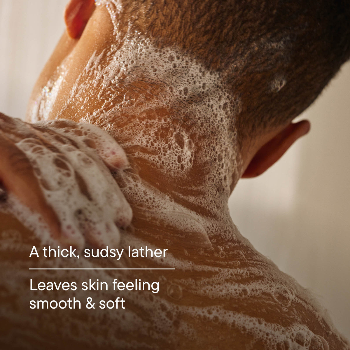 Person with foamy soap on their neck, with text about the lather's texture and skin feeling.