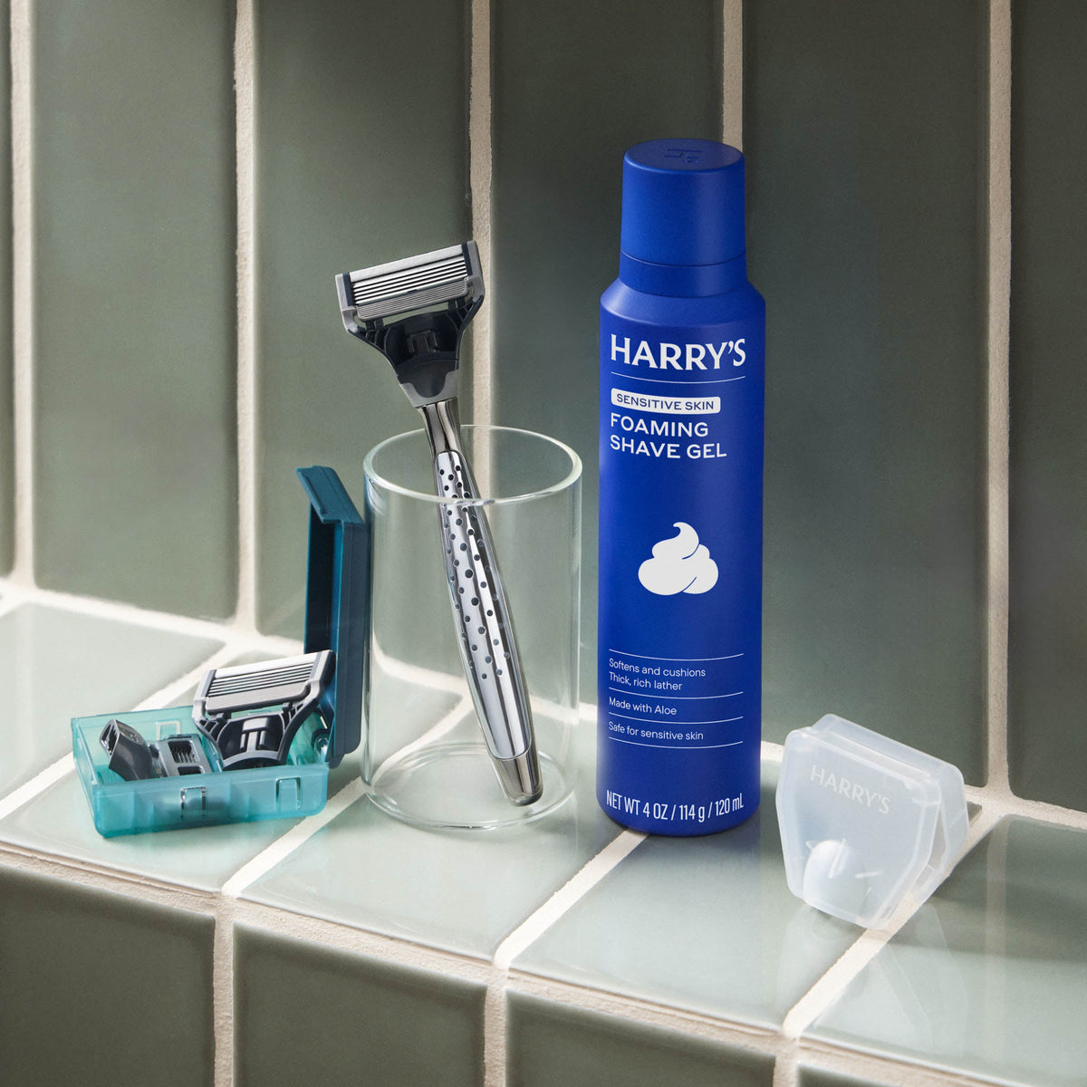 Harry's shaving products including a bottle of foaming shave gel, razor, and razors on a bathroom counter.