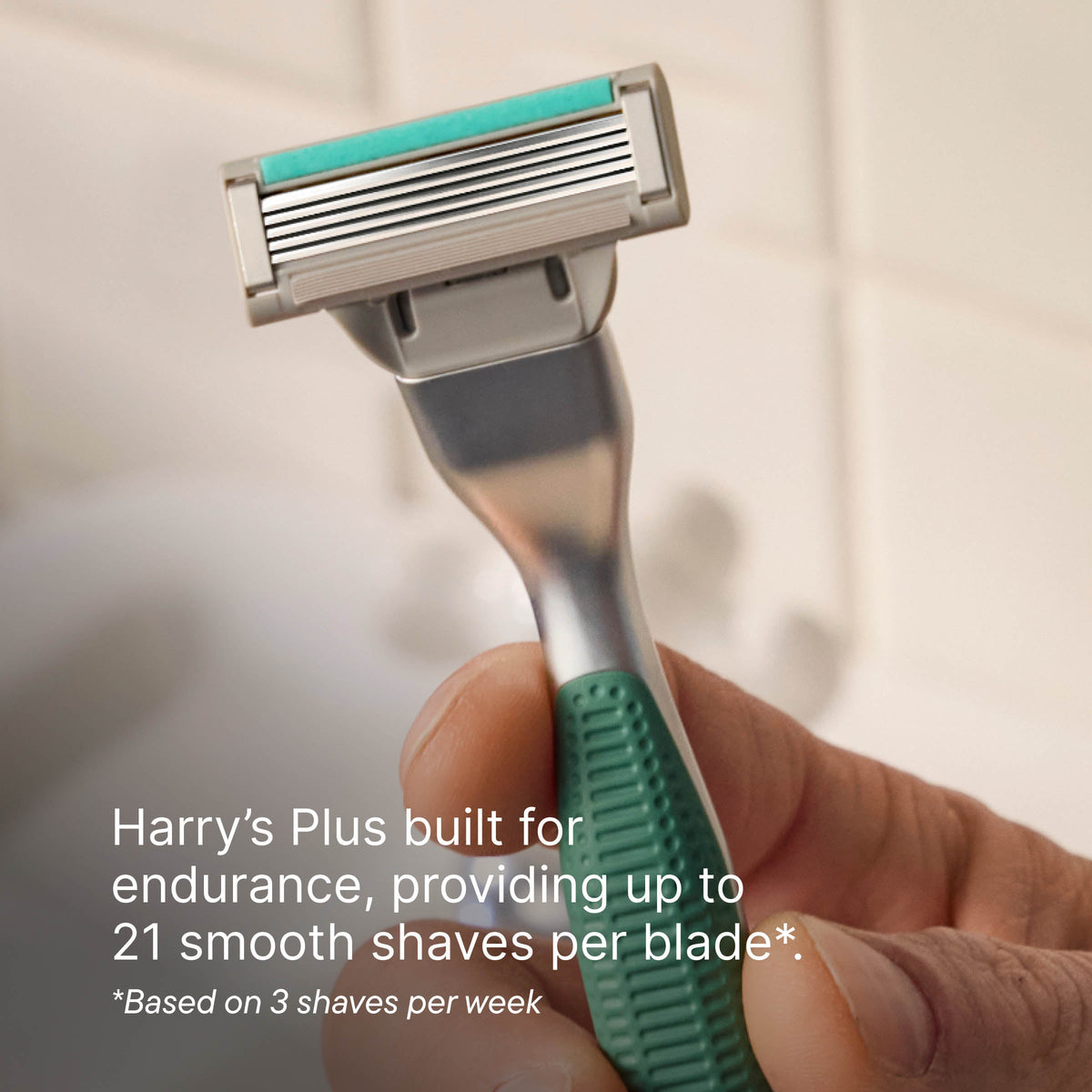 Hand holding a green and silver razor with text about endurance and shaving frequency.