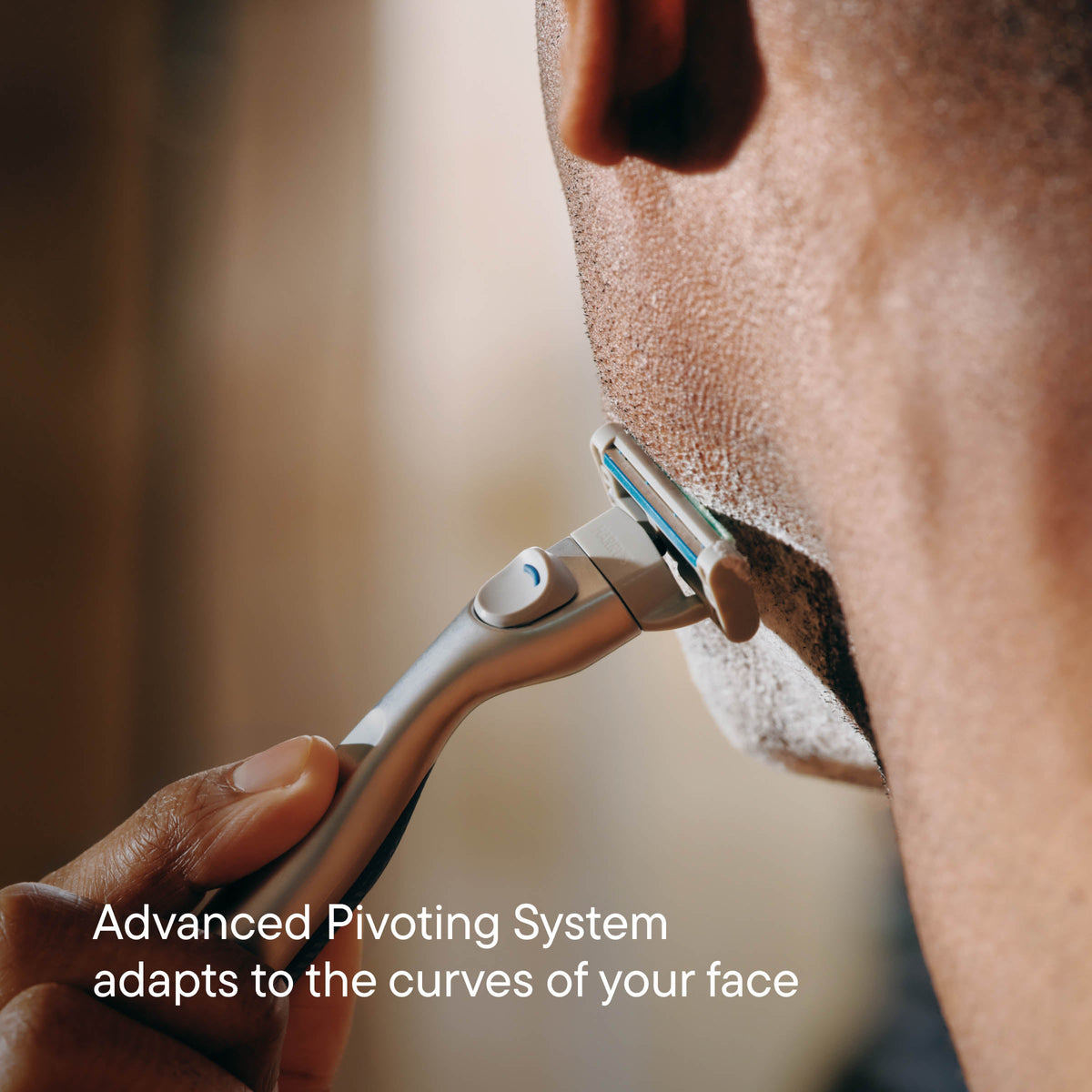 Person using a razor with an advanced pivoting system on their face.