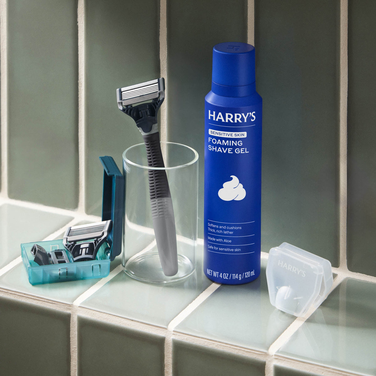 Harry's shaving products including a bottle of foaming shave gel, razor, and razors on a bathroom counter.