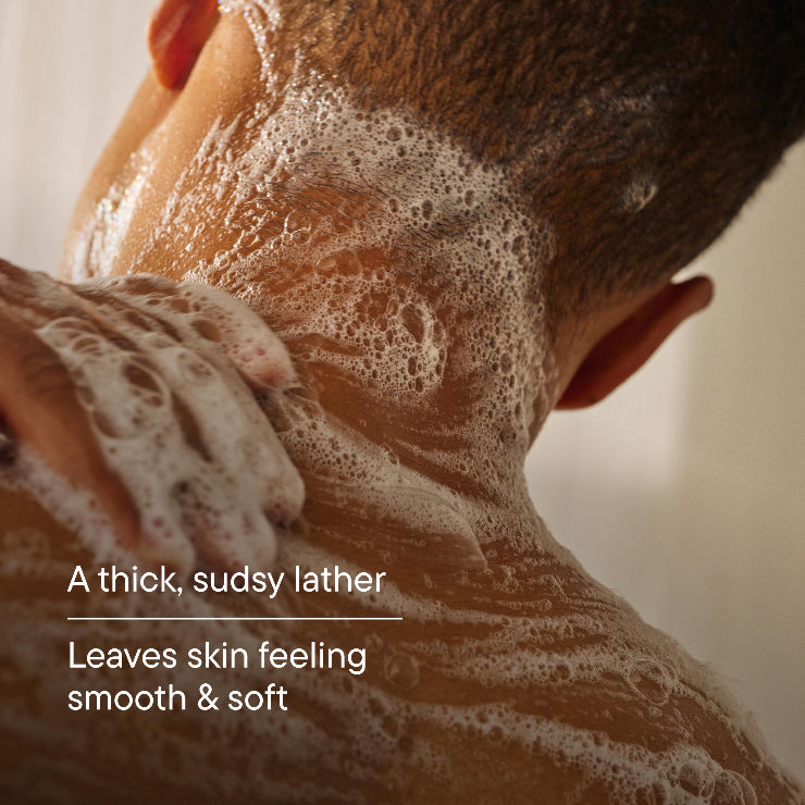 Person applying soap to the back of their neck with text " A thick, sudsy lather. Leaves skin feeling smooth & soft."