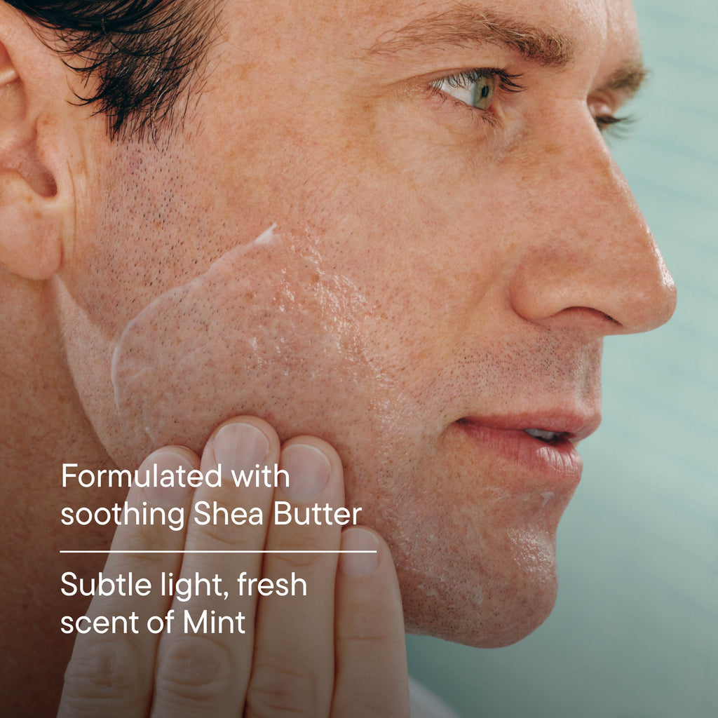 Man applying a skincare product to his face with a light blue background