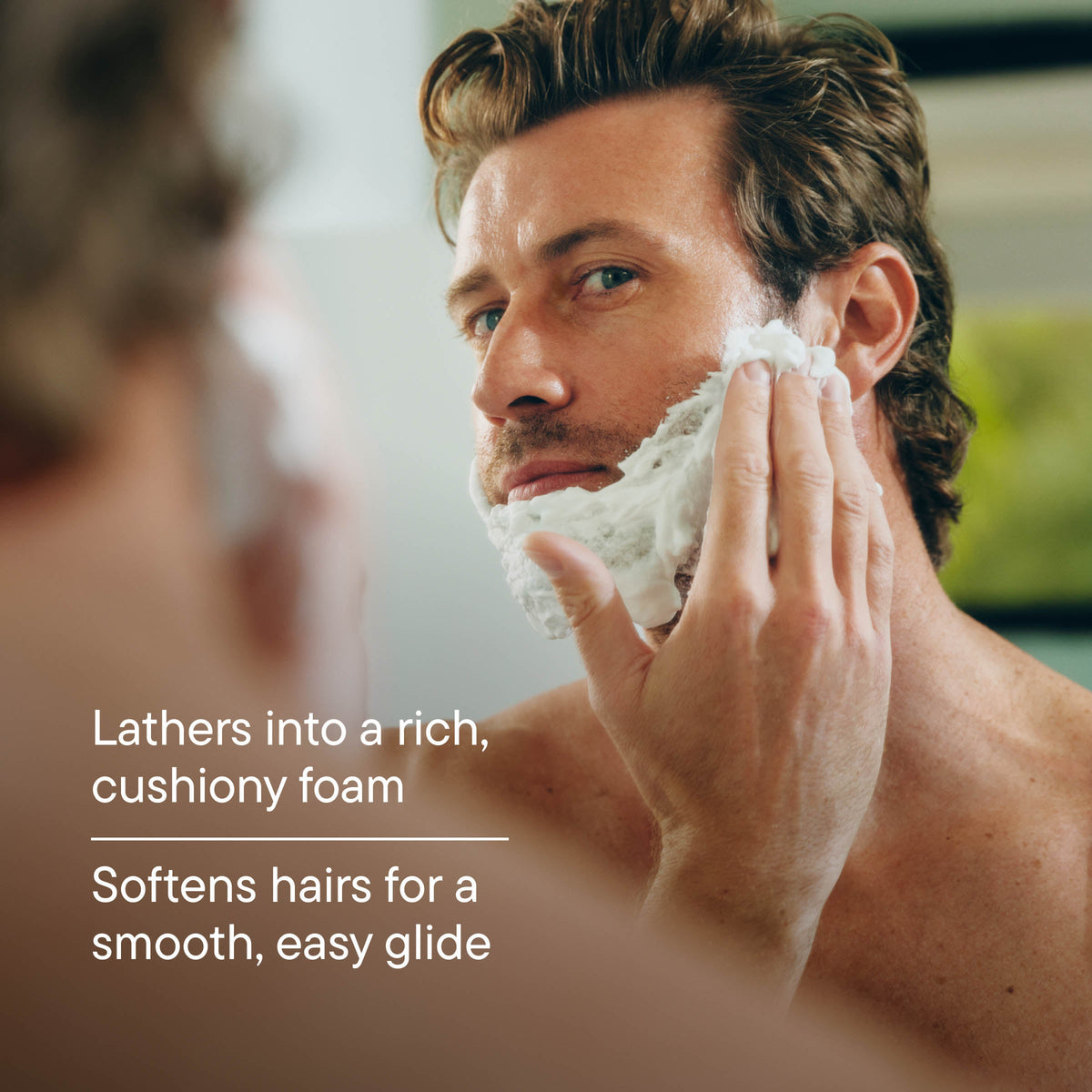 Man shaving with a razor, with text about lathering foam and smooth glide.
