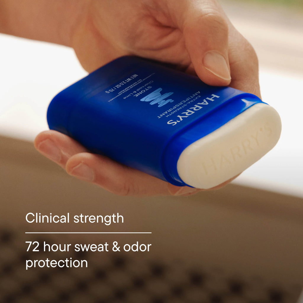 Hand holding a blue antiperspirant stick with 'HARRY'S' branding, labeled as clinical strength with 72-hour sweat & odor protection.