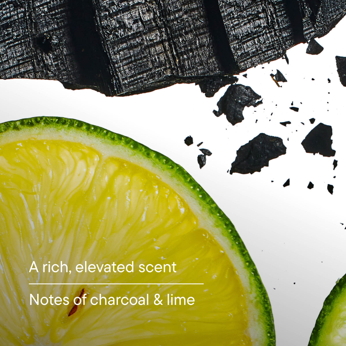 Sliced lime with charcoal pieces on a white background