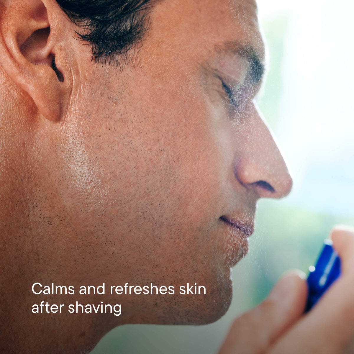 Close-up of a man applying aftershave to his face with text 'Calms and refreshes skin after shaving'.