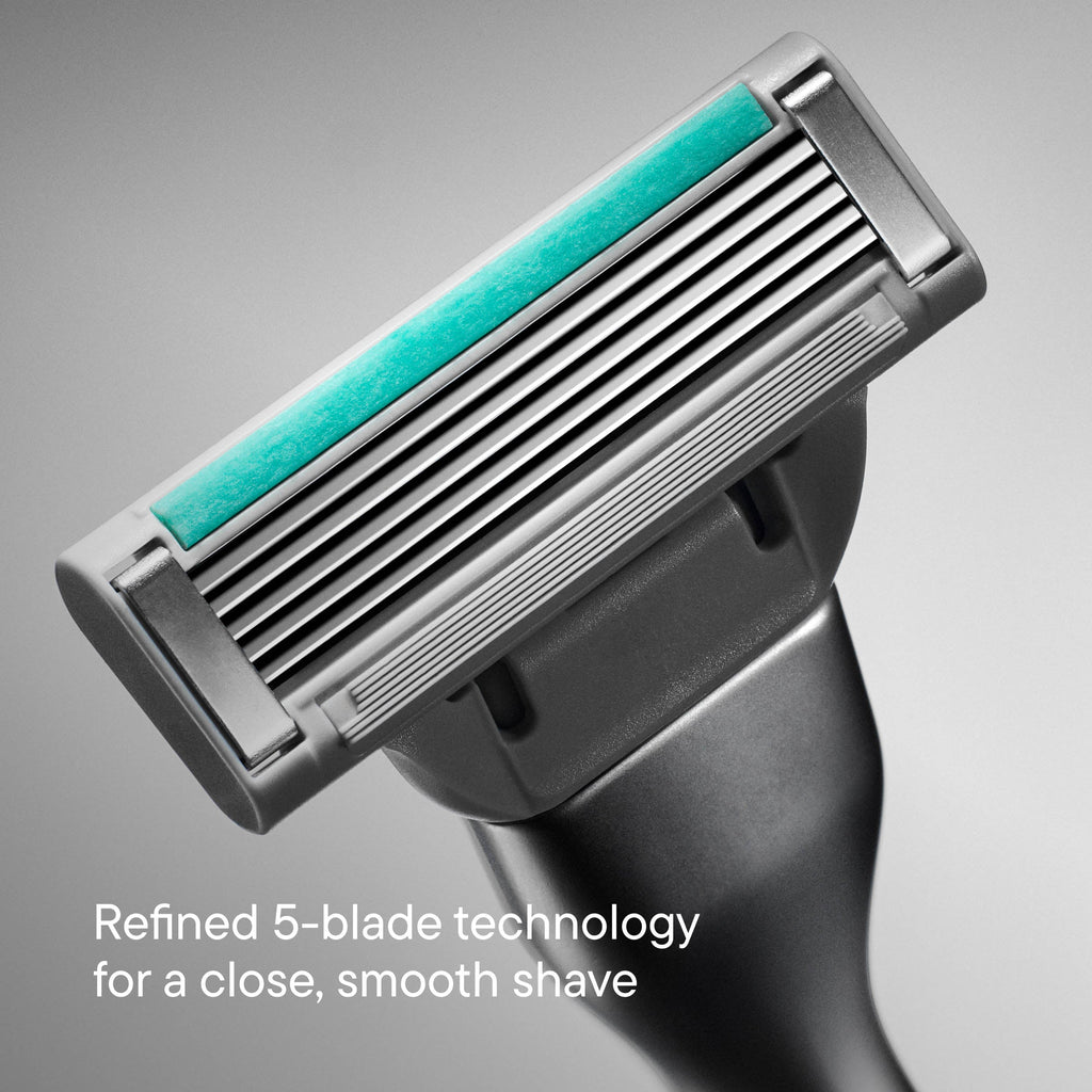 Shaving razor with five blades on a gray background