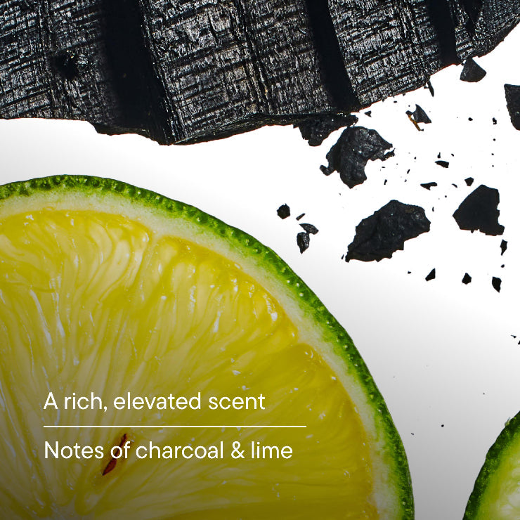 Sliced lime with charcoal pieces with text 'A rich, elevated scent Notes of charcoal & lime'.