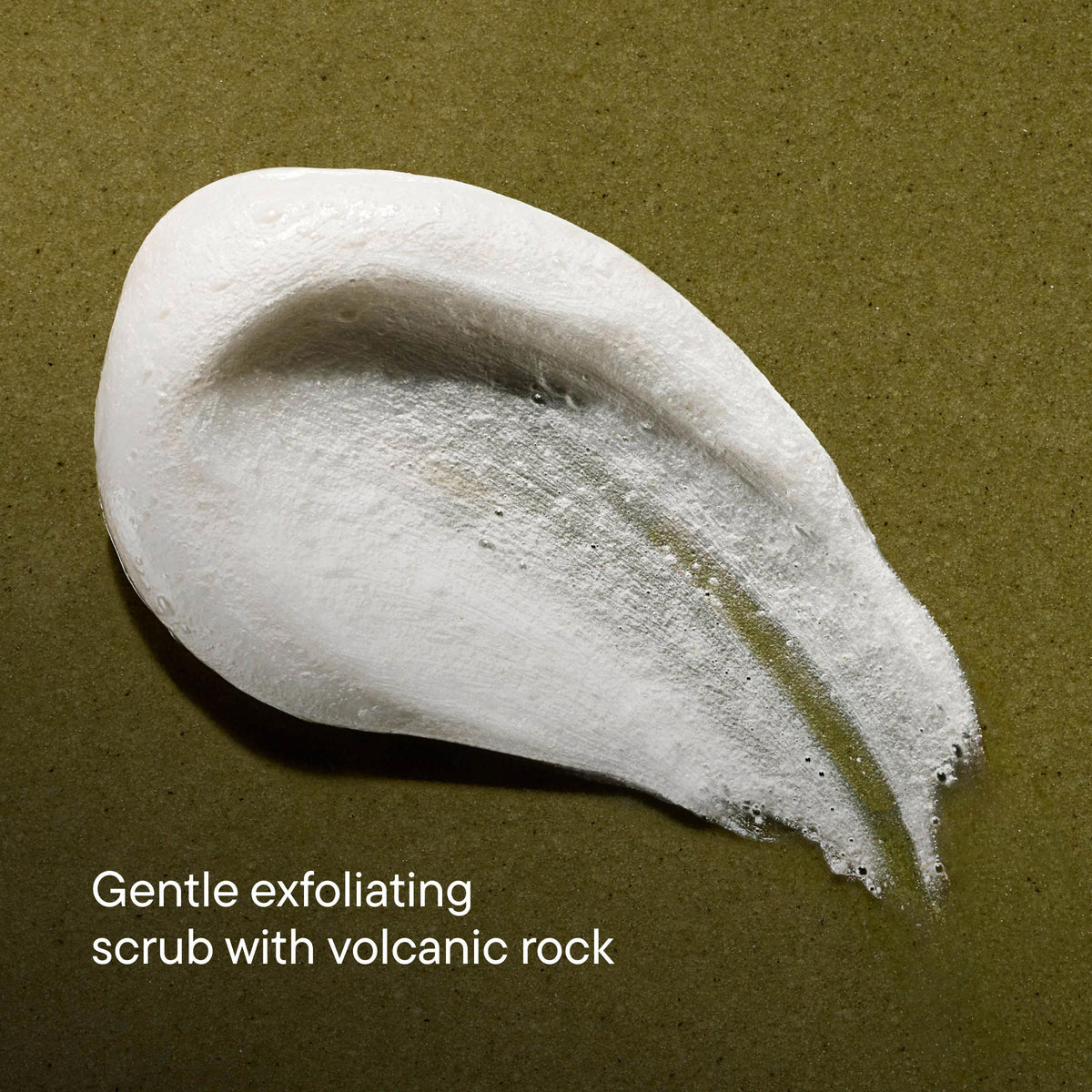 White exfoliating scrub with volcanic rock on a brown background