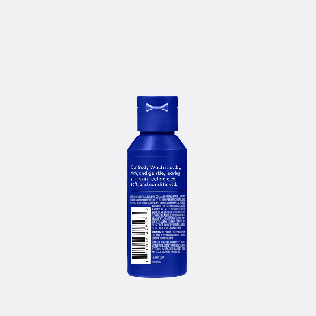 Blue bottle of body wash with text on a light gray background