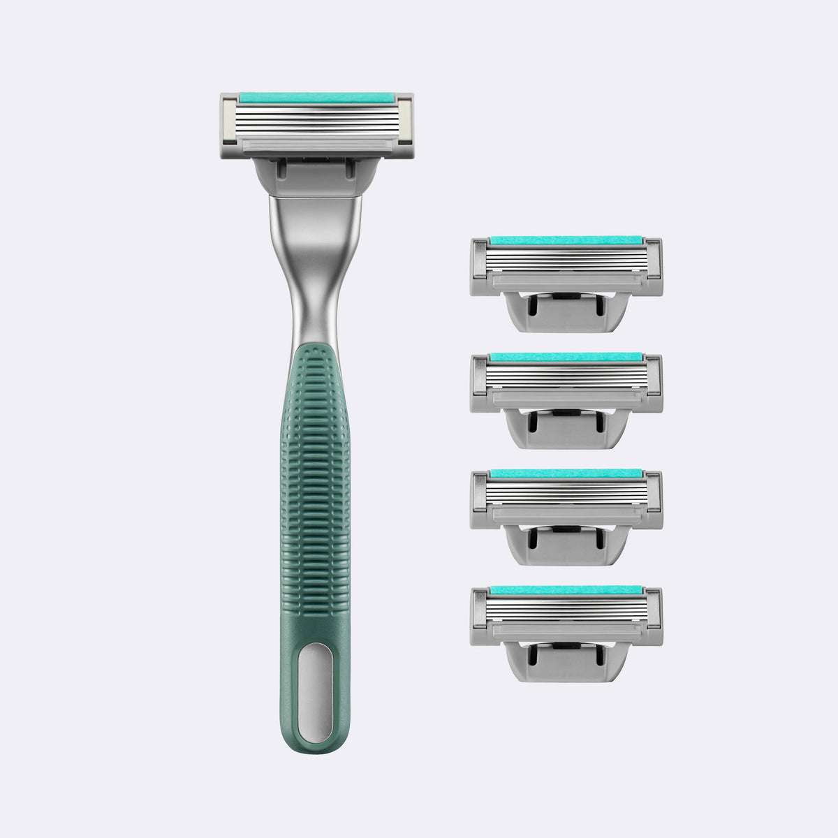 Men's grooming kit with a green razor and four razor heads on a light gray background