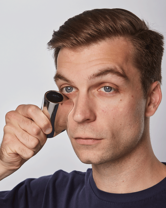 man using metal gauche applicator under his eye
