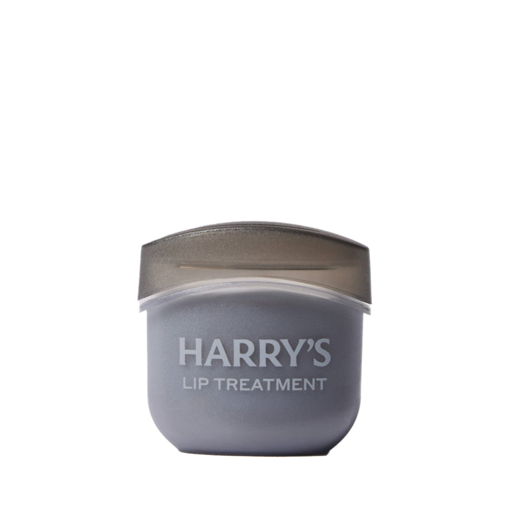 Lip treatment container with 'HARRY'S' branding on a white background