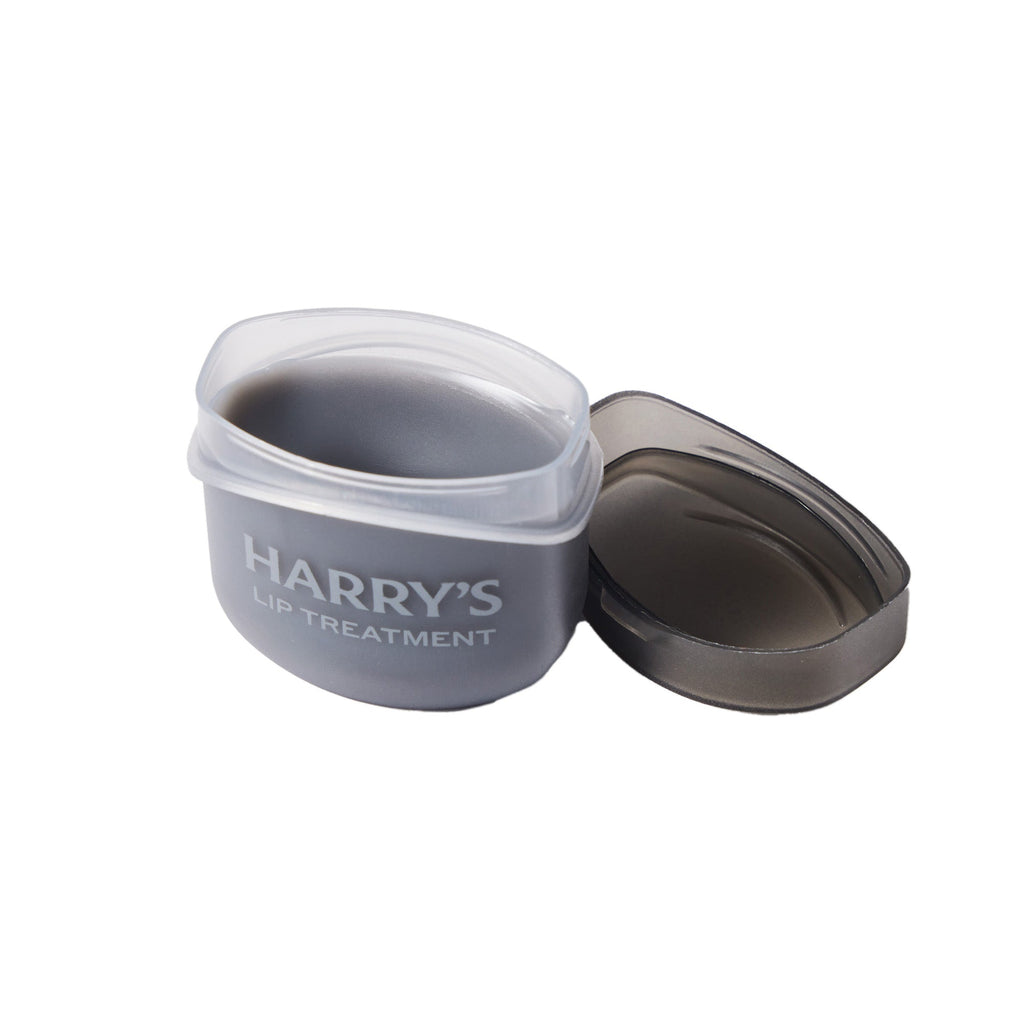 Gray container labeled 'Harry's Lip Treatment' on a white background