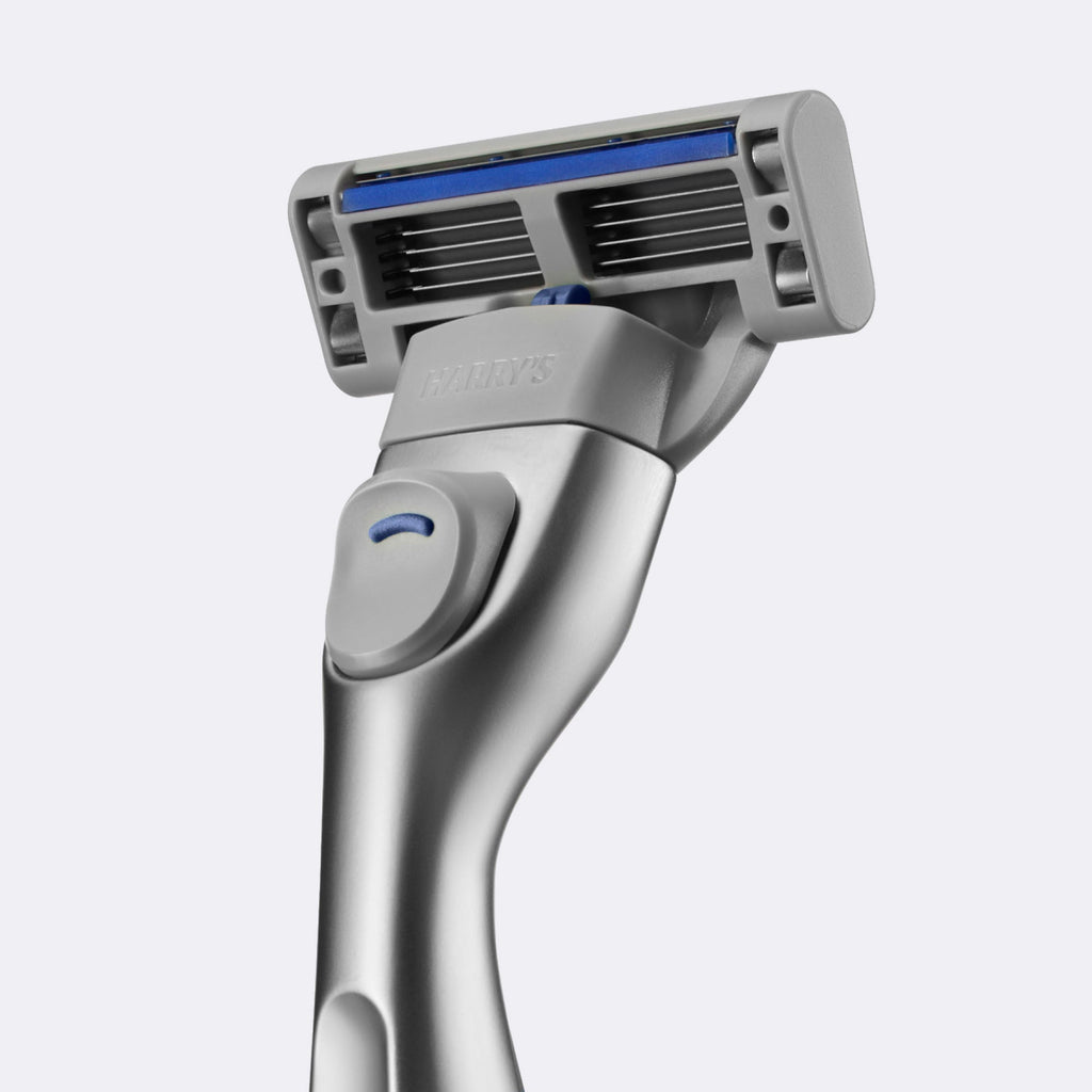 Silver Harry's razor on a light gray background