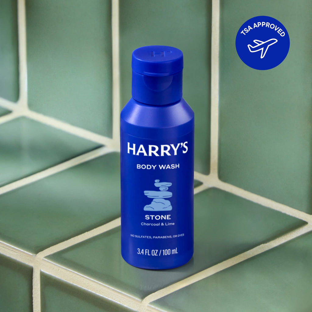 Blue bottle of Harry's Body Wash against a green tile background