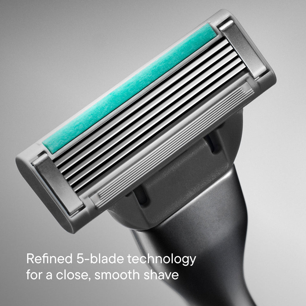 Shaving razor with five blades on a gray background
