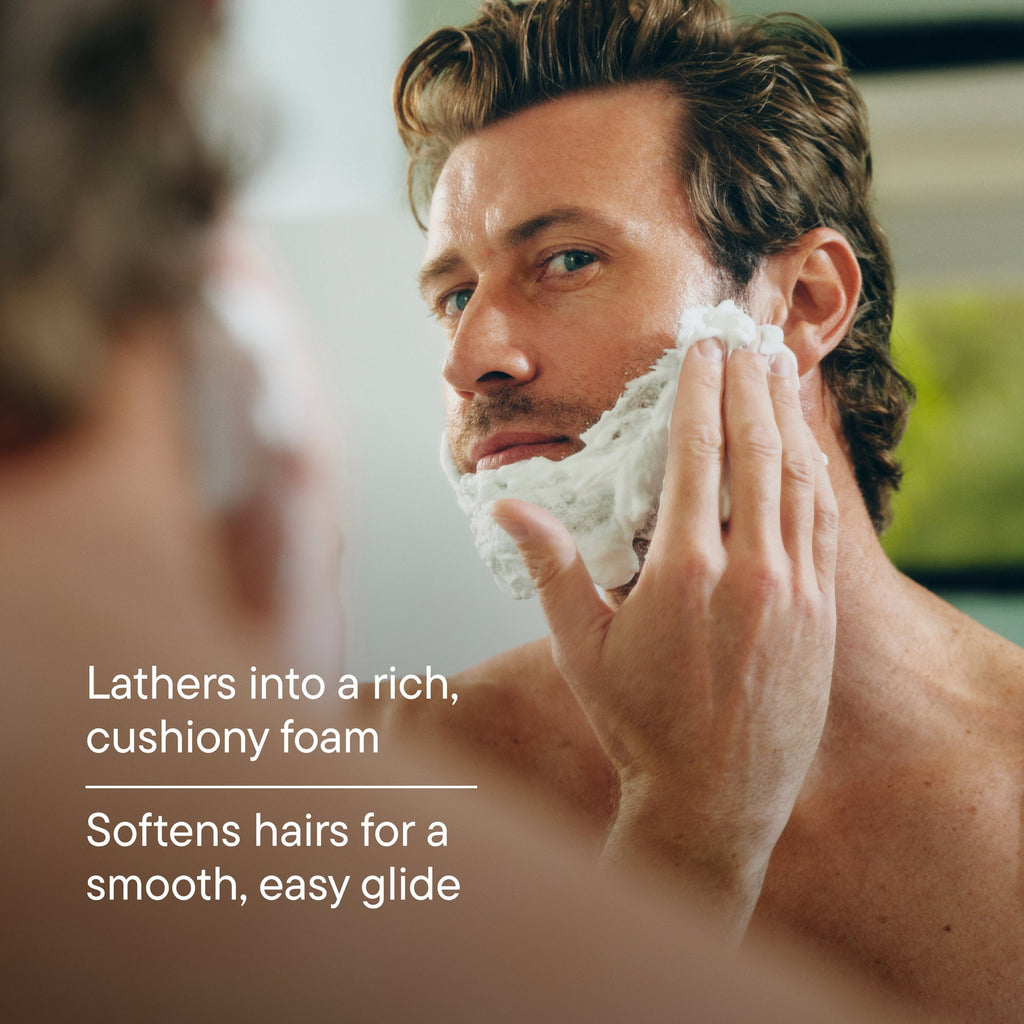 Man shaving with a razor, with text about lathering foam and smooth glide.